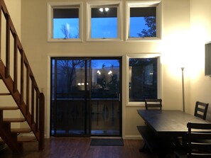 Dining table area with slider to wrap around deck and stairs to loft 