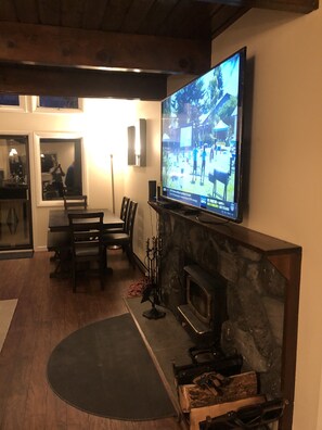 Living room  with fireplace and 70” smart tv 