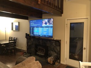 Living room with fireplace, 70” smart TV and 2nd access to wrap around deck 