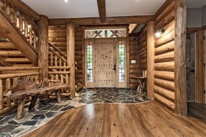 The first view of inside the Chalet is the front entrance.  Stone floor at the entrance and beautiful hardwood floors throughout.  