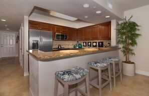 Kitchen space and bartop seating for three