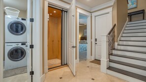 A convenient home elevator located just off the stairs