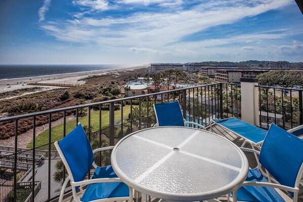 Balcony with ocean and pool views