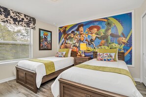 Adorable Toy Story themed twin bedroom with flat screen TV