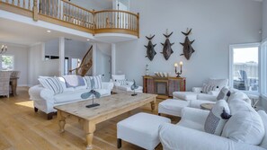 Bright and airy living room with white slipcovered furniture and coastal decor