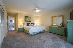 Spacious primary bedroom with king sized bed
