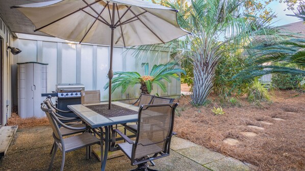 Private patio with gas grill and outdoor seating