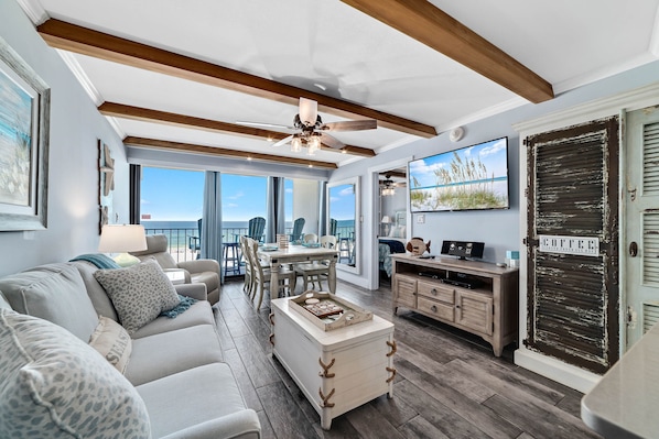 Open Plan Living Area with Comfortable Queen Size Sleeper Sofa with Sweeping Floor to Ceiling Views of the Gulf of Mexico