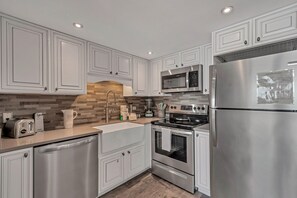 Fully Equipped Upgraded Kitchen with Quartz Countertops and Stainless Steel Appliances