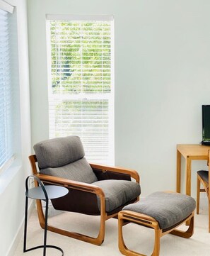 Down-filled lounge chair in corner of the master bedroom. 