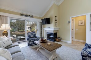 Spacious living room with fireplace and TV