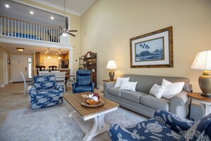 Open concept living room with coastal features