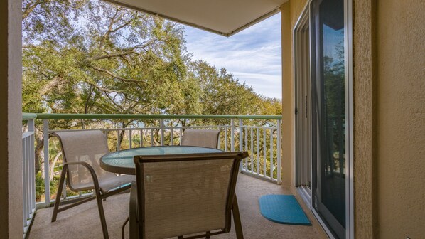 Private balcony overlooking community grounds and ocean views