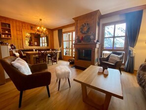 Open plan living and dining area with sofa bed and fireplace