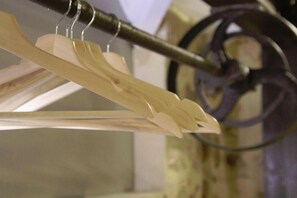 A repurposed pulley shaft is now a clothes hanging rail