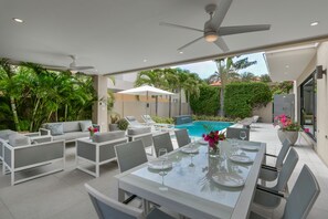 Backyard with covered gazebo area including dining, lounging and outdoor kitchen