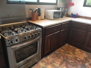 Six burner gas stove/oven and custom wood cabinetry