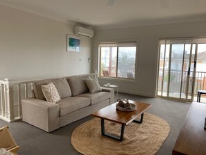 Comfortable open plan lounge area with large TV.