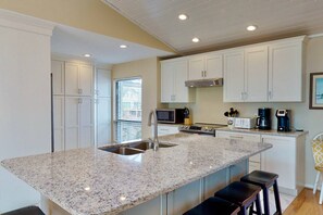The kitchen has been redesigned and updated with granite counters, new appliances, flooring and cabinets