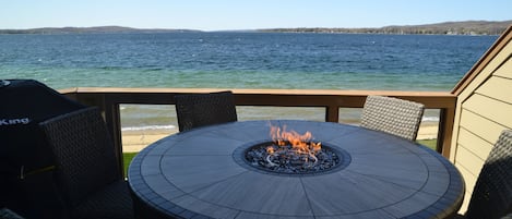 Lake view from main floor deck. Fire it dining table. Seats 6.