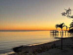 Southwest view of beach at sunset from patio. 