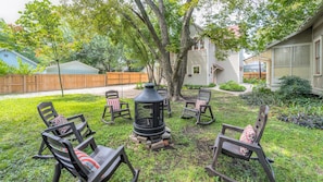 Shared Fire Pit with big rockers all under a beautiful old pecan tree canopy.