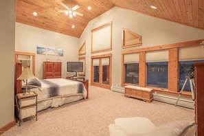 Master bedroom with water views, balcony, and a second deck