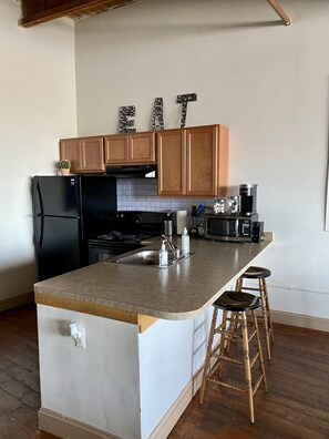 Fully stocked kitchen for convenient cooking. 