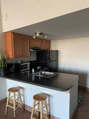Full size kitchen with coffee bar and stocked with cooking essentials 