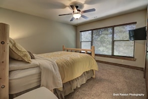 Upstairs, this queen size bedroom is a favorite for its views directly out to the lake! Also enjoy a TV & large closet.