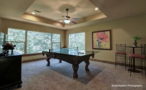 Upstairs enjoy a ping pong / pool table, GIANT windows that overlook the lake, a TV, and bistro set.