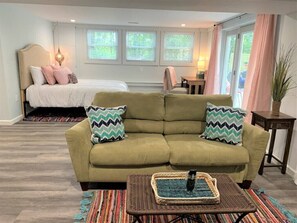 Bedroom with Queen Bed, Desk and Loveseat. 