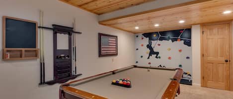 Recreation area with pool table and wall climbing for kids