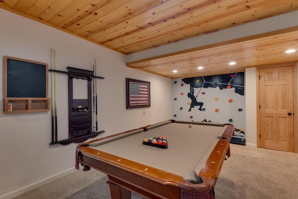 Recreation area with pool table and wall climbing for kids