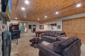 Recreation area with comfy seating, flat screen tv, arcade, pool table, and wall climbing for kids