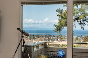 Use the telescope and binoculars to spot bald eagles, boats, and Victoria BC across the water