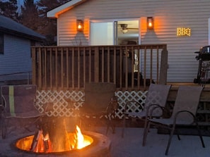 Picture of the new firepit, BBQ area and Hot tub on back deck overlooking the lake.