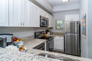 Open Kitchen for the Chef of the Group to Communicate with the Dining & Living Area