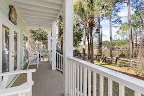 Covered porch with chairs.