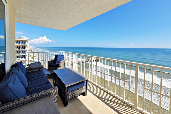 This 11th floor unit provides spectacular views from its oceanfront balcony that features seating and tables.