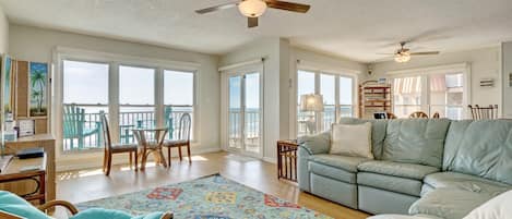 Stunning beach and ocean views greet you through glass sliding doors in the kitchen and living room. Relax on the comfy sectional or step out to the balcony for the perfect cup of morning coffee!  #SeasideSerenity