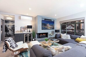 Living room featuring cozy gas fireplace, beautiful bar/server, air conditioning, and much more