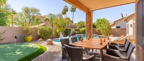 Private resort backyard with pool, putting green and outdoor dining!