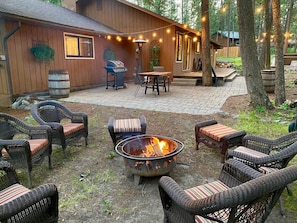 Outdoor seating, cooking and eating. Firepit along with a stack of wood included.