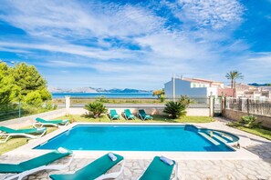 House with pool in front of the sea.