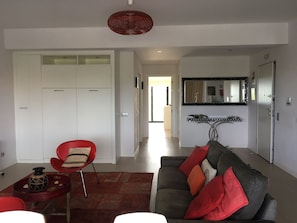 Open plan living/dining/kitchen area with direct access to private terrace.