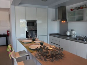Kitchen with oven, microwave, hob, dishwasher, washing machine, fridge/freezer
