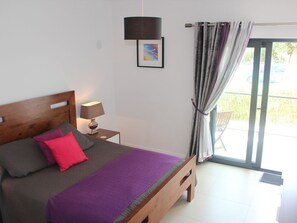 Bedroom with king size bed and private terrace. Ample storage