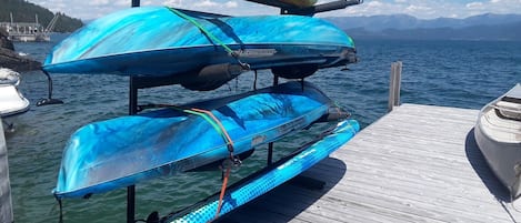 Three kayaks and a paddleboard