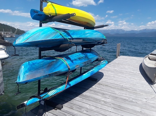 Three kayaks and a paddleboard